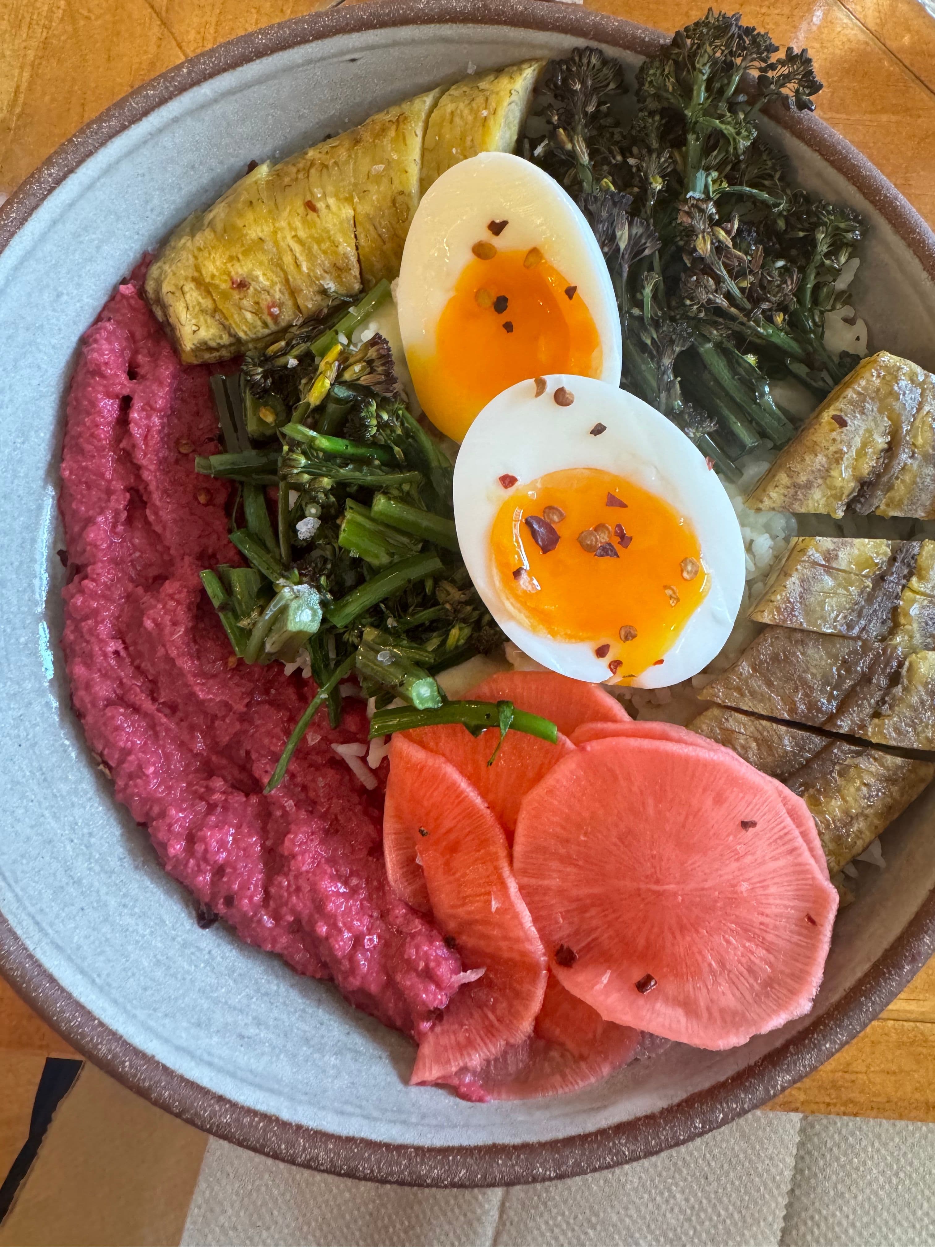 A delicious bowl with vegetables and boiled egg.